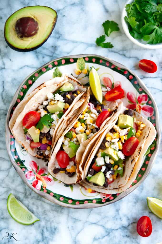 Grilled yellow corn and black bean tacos on festive plate
