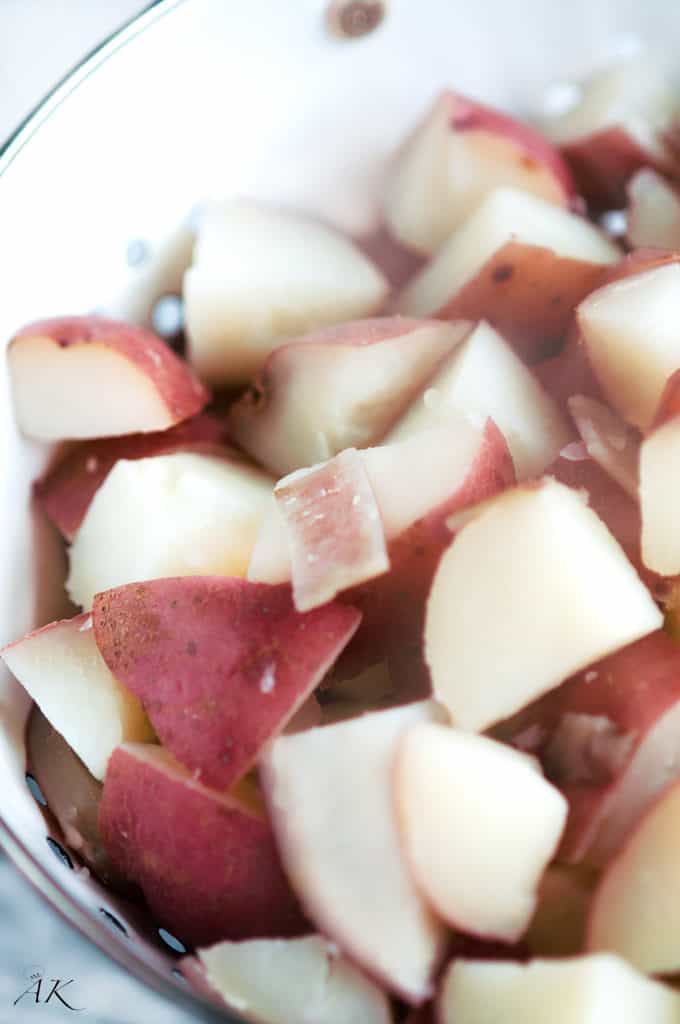 boiled red potatoes in a strainer