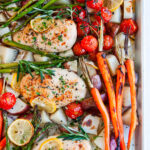 One Pan Lemon Herb Chicken on sheet pan with fresh veggies on white marble overhead view