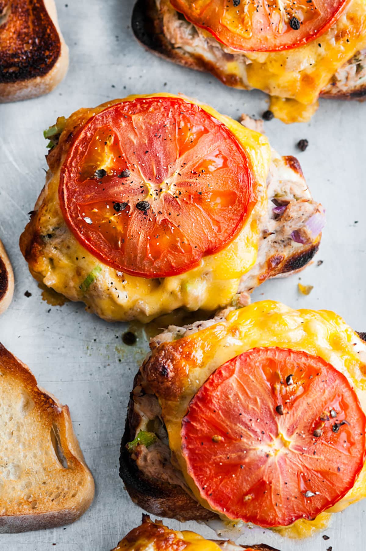 Sheet Pan Sourdough Tuna Melts open faced sandwich style broiled on gray baking sheet with melted