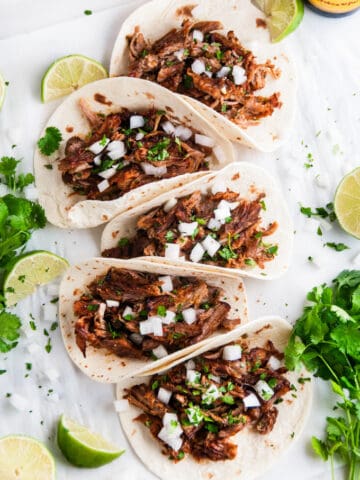 Slow Cooker Pork Carnitas Tacos with cilantro and limes