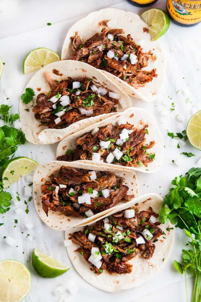 Slow Cooker Pork Carnitas Tacos with cilantro and limes