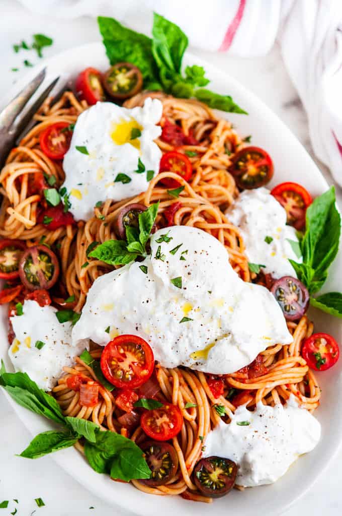 Tomato Basil Spaghetti with Burrata on a Serving Platter with Fork