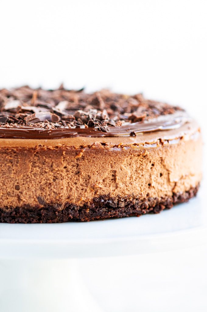 Triple Chocolate Cheesecake with ganache and chocolate shavings side close up