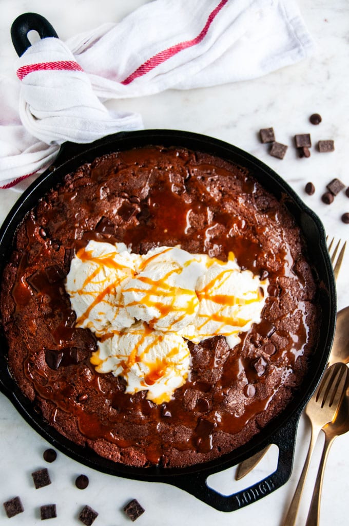 Chocolate Caramel Skillet Brownie in lodge cast iron skillet with vanilla ice cream