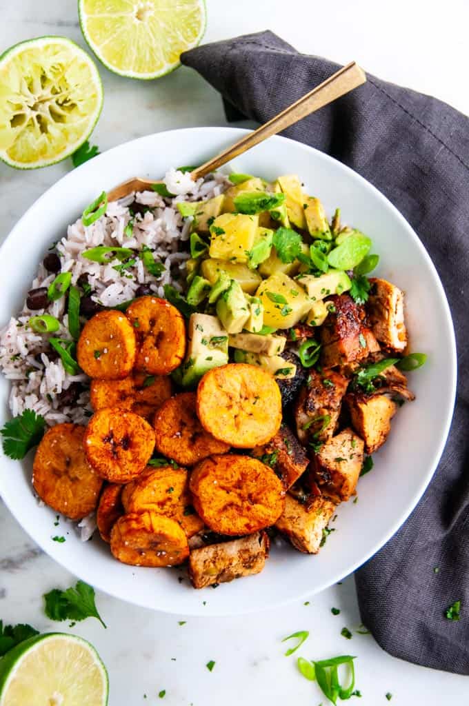 Cuban Chicken Bowls with Fried Plantains with gold fork and gray towel