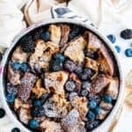 Instant Pot Cinnamon Berry French Toast Casserole in a gray pan with gold forks and towel