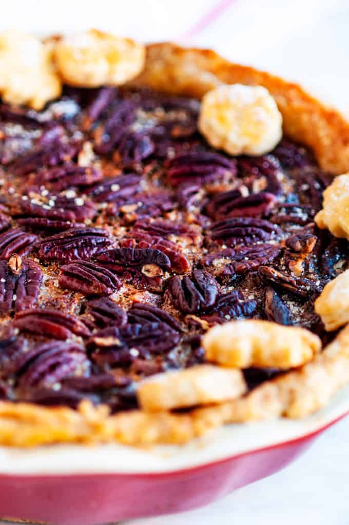 Deep dish bourbon pecan pie on marble with white towel