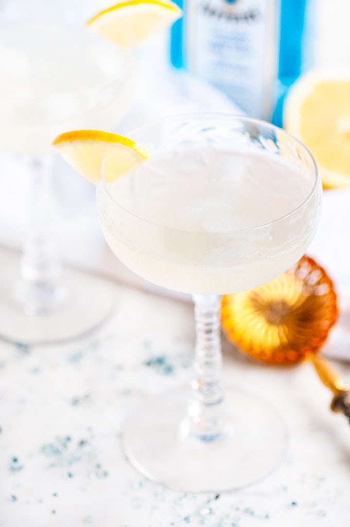 French 75 Cocktail with gold strainer and bombay sapphire gin