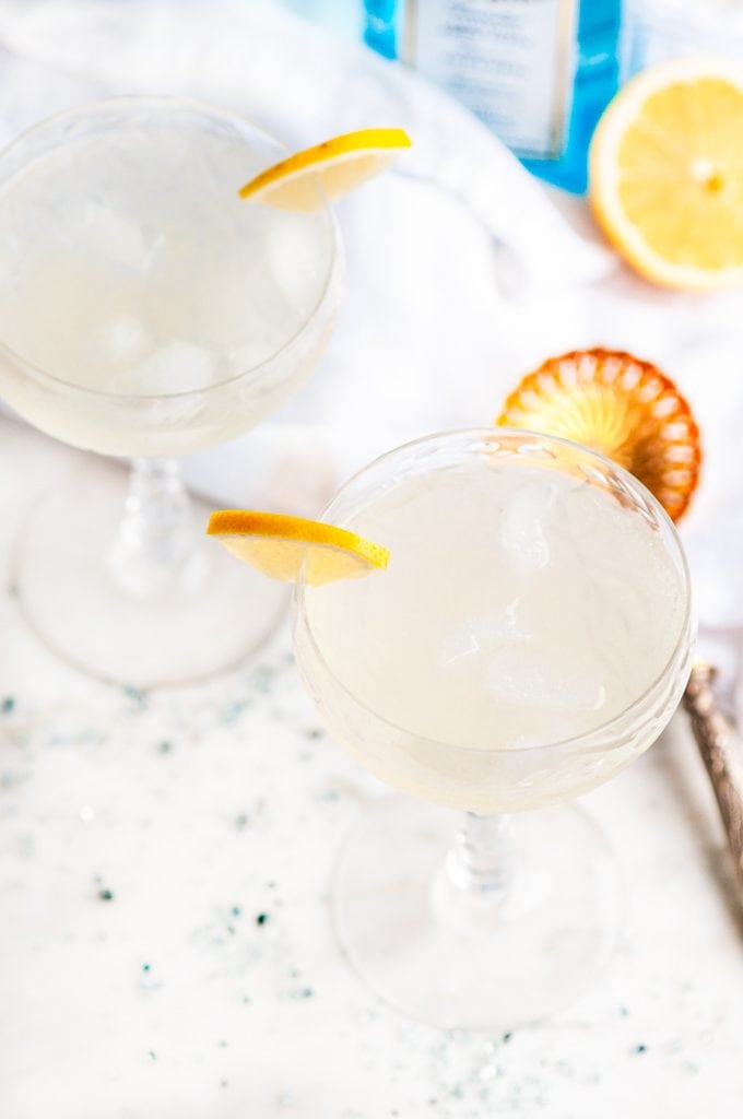 French 75 Cocktail with gold strainer and bombay sapphire gin