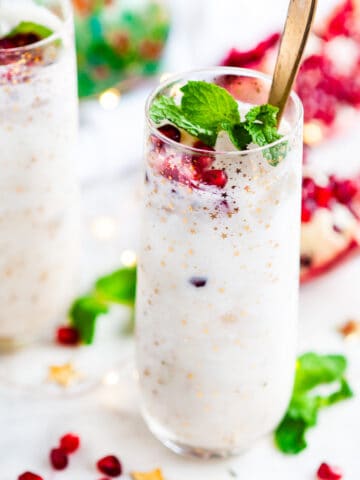 White Christmas Coconut Whiskey Cocktail with mint and pomegranate seeds