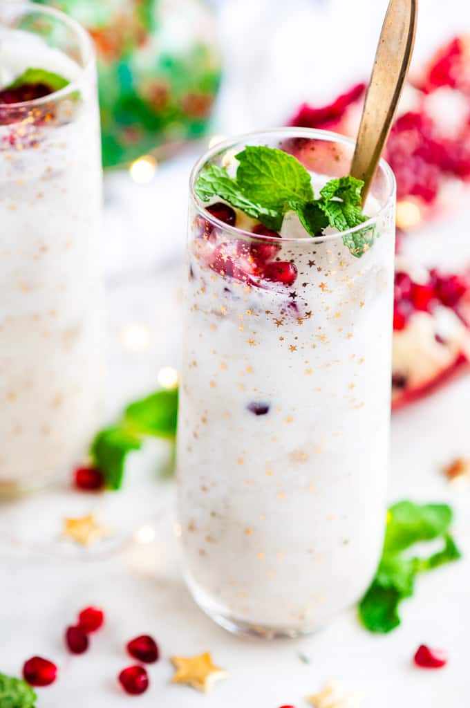 White Christmas Coconut Whiskey Cocktail with mint and pomegranate seeds