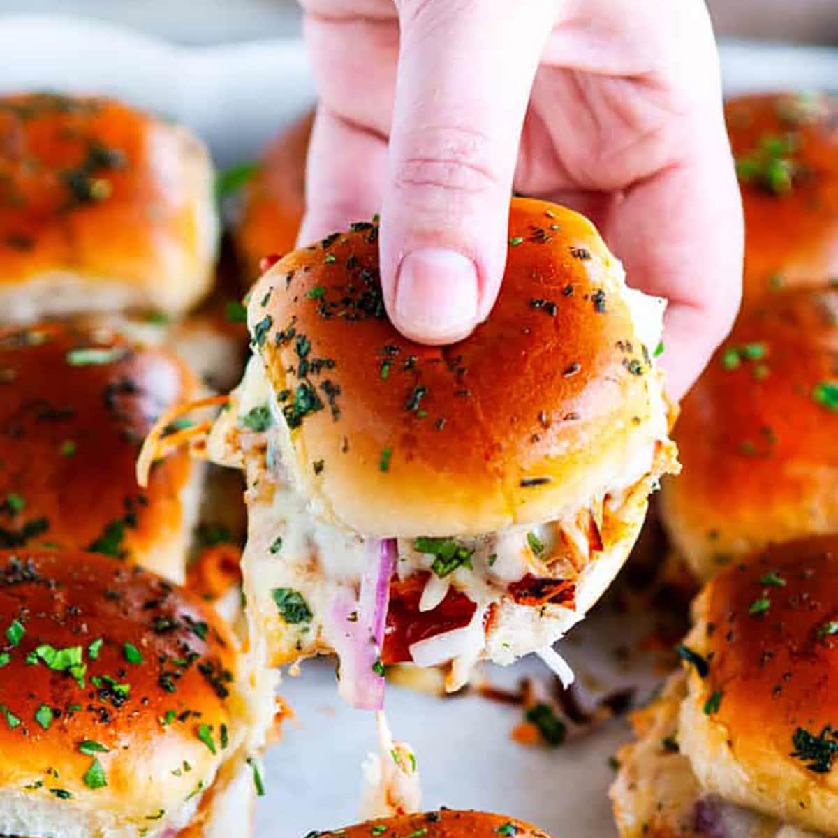 BBQ chicken sliders melted cheese with hand
