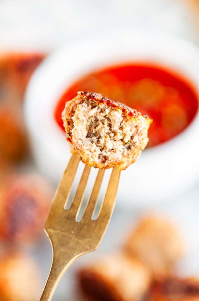 Baked Turkey Meatballs with marinara dipping sauce and gold fork