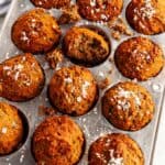 Coconut Banana Almond Muffins in gray tin on white marble