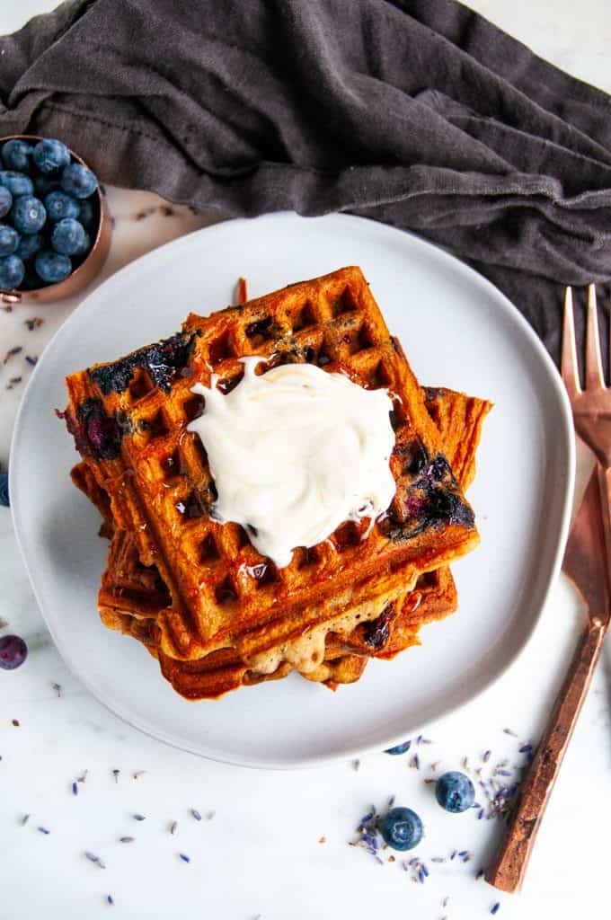 London Fog Blueberry Waffles with copper silverware and gray tea towel