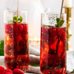 Raspberry Rosé Gin Fizz Cocktail with mint and gold spoons