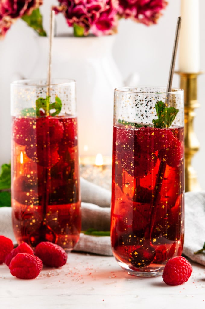 Raspberry Rosé Gin Fizz Cocktail with mint and gold spoons