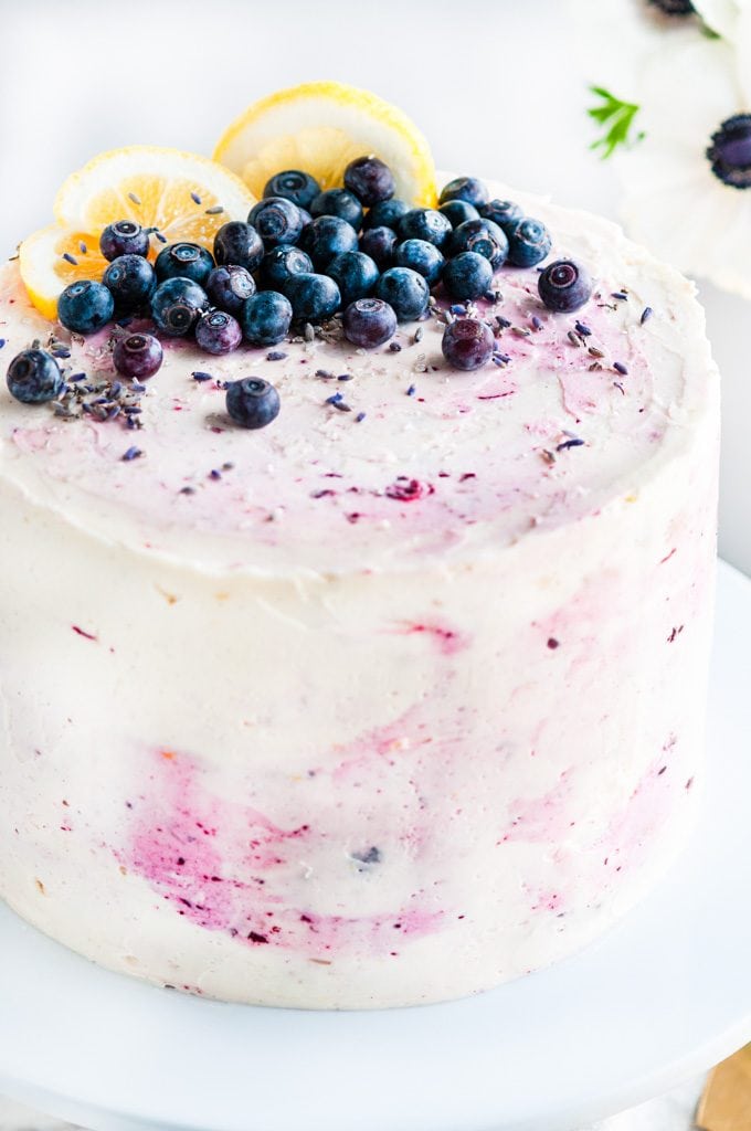 Lemon Blueberry Lavender Cake with Mascarpone Buttercream Frosting on white cake stand