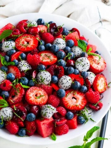 Berry Watermelon Dragon Fruit Salad with mint in white bowl