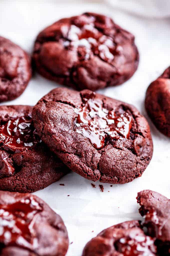 Triple chocolate chip cookies on white parchment paper