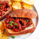 Best Ever Sloppy Joes with chips on white plate and marble