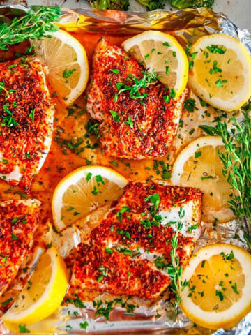 Sheet Pan Paprika Parmesan Cod with Broccoli in foil with lemons and herbs