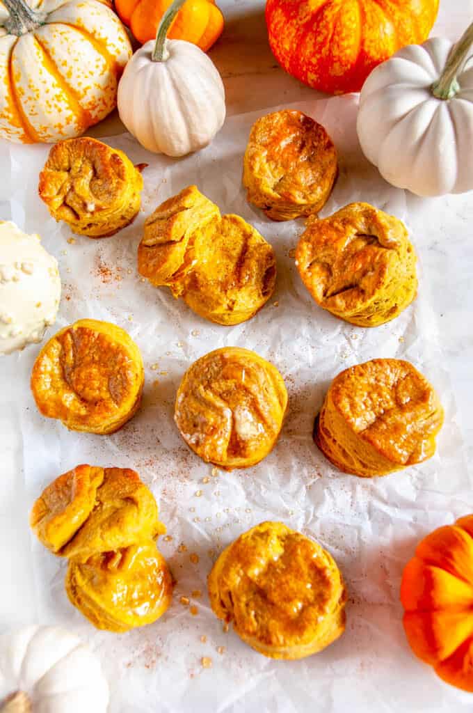 Pumpkin Buttermilk Biscuits with butter and honey on white parchment paper