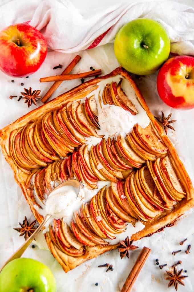 Chai Spice Apple Galette with vanilla ice cream, star anise, and cinnamon sticks on white marble