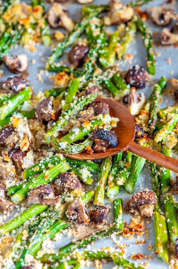Roasted Panko Asparagus and Mushrooms on sheet pan with wooden spoon close up