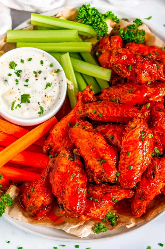 Crispy Buffalo Chicken Wings (Air Fryer + Oven Baked Methods) with carrots, celery and blue cheese dressing close up