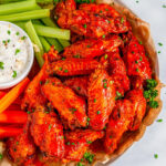 Crispy Buffalo Chicken Wings (Air Fryer + Oven Baked Methods) with carrots, celery and blue cheese dressing close up