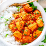 Instant Pot Chicken Tikka Masala in white bowl with basmati rice, cilantro and gold fork