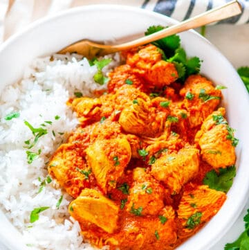 Instant Pot Chicken Tikki Masala in white bowl with basmati rice, cilantro and gold fork