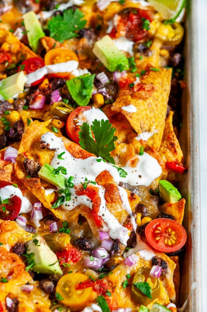 Loaded Vegetarian Sheet Pan Nachos with black beans and corn close up