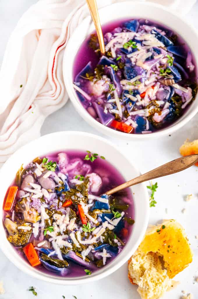 White Bean Purple Cabbage Soup with gold spoons in white bowls