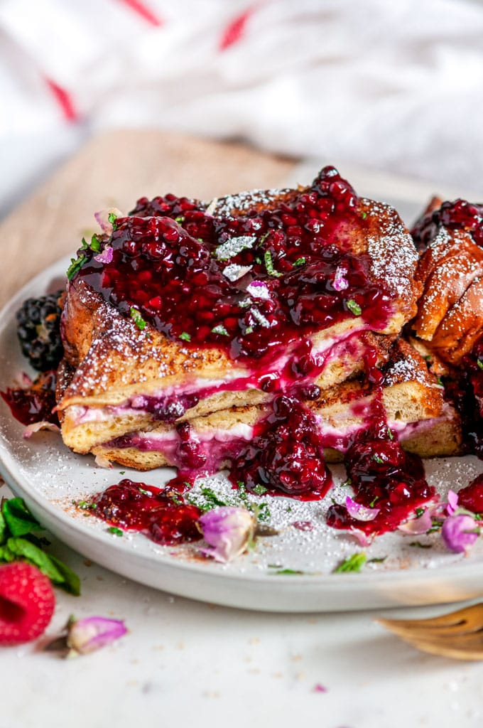 Cream Cheese Stuffed Blackberry Compote French Toast on gray plate with flowers close up