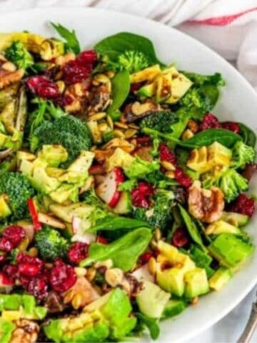 Easy Everyday Side Salad in white bowl on marble with tea towel