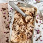 No Churn Chocolate Chunk Coffee Ice Cream with scoop on white marble with flowers