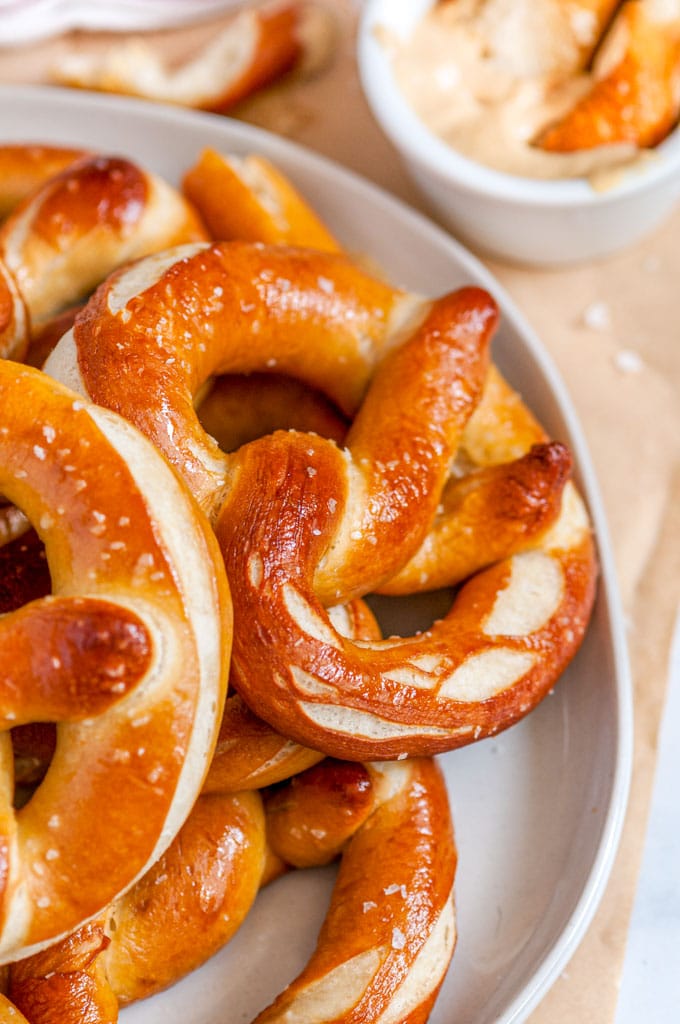 Homemade Buttery Soft Pretzels on gray plate with mustard close up