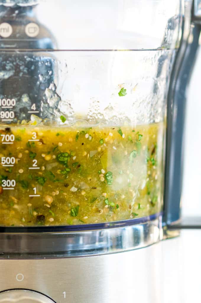 Roasted Tomatillo Salsa Verde in food processor side view close up