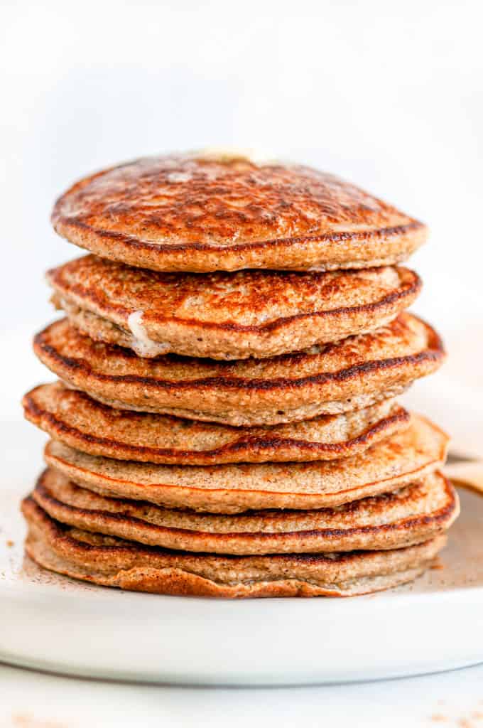 Fluffy Banana Oat Pancakes (Gluten Free) stack with butter on top side view close up