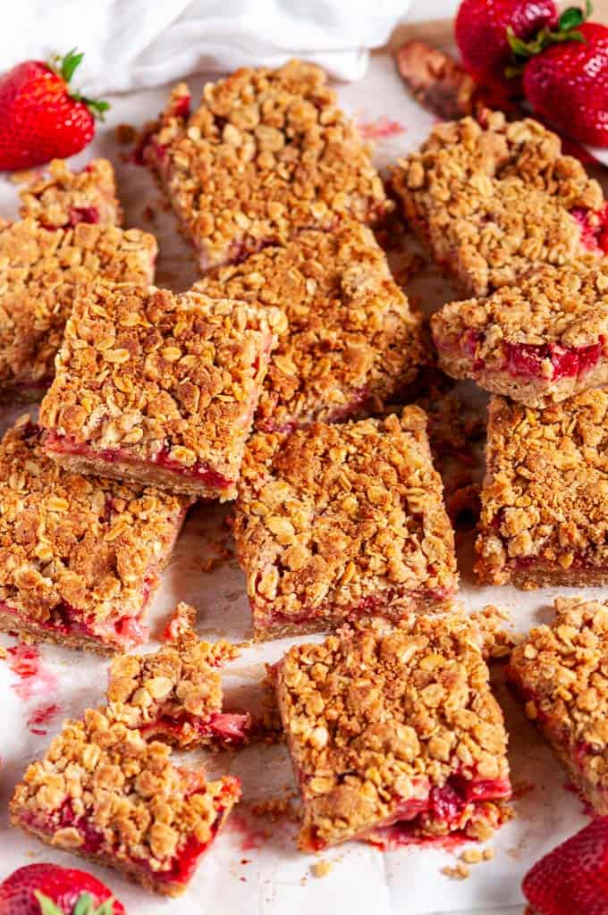 Strawberry Rhubarb Crumble Bars on parchment and white marble sliced over head