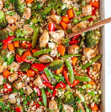 Sheet Pan Sesame Chicken with Veggies with wood spoon over head