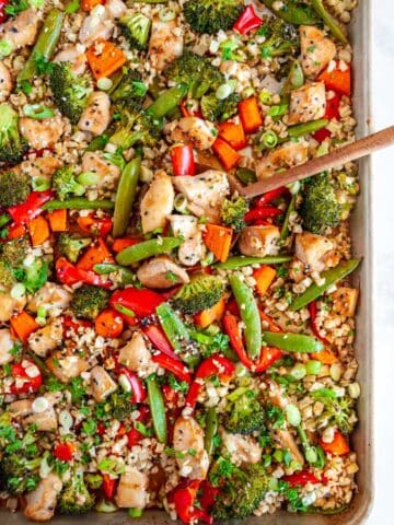 Sheet Pan Sesame Chicken with Veggies with wood spoon over head