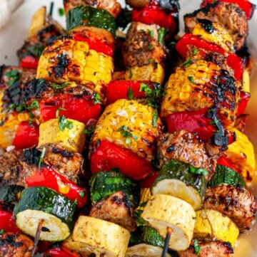 Balsamic Chicken Vegetable Kabobs on white platter overhead view close up