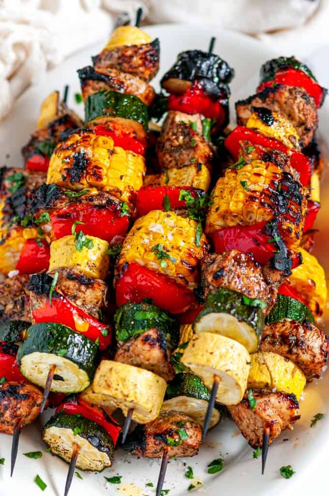 Balsamic Chicken Vegetable Kabobs on white platter overhead view close up