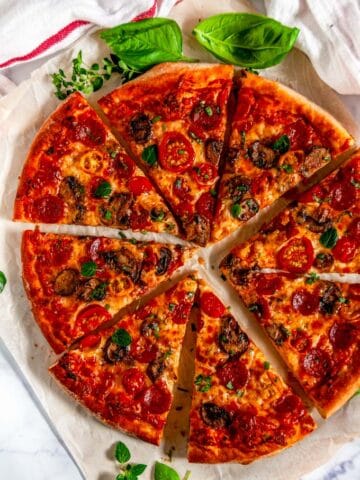 Cheesy Pepperoni Mushroom Pizza sliced over head view