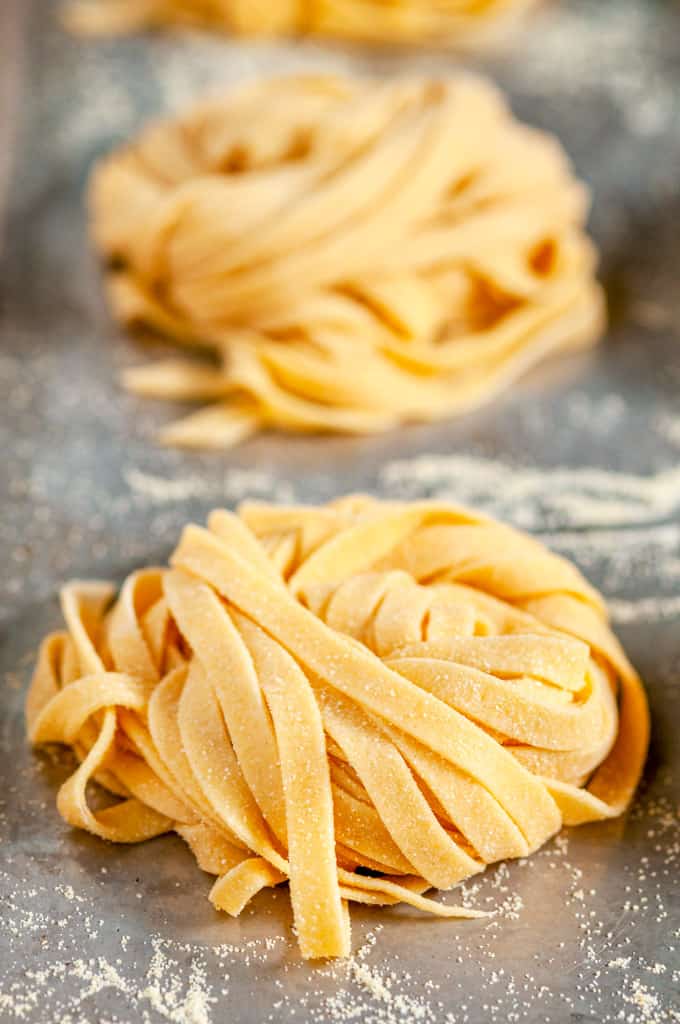 Homemade Pasta Dough Recipe nests on baking sheet close up