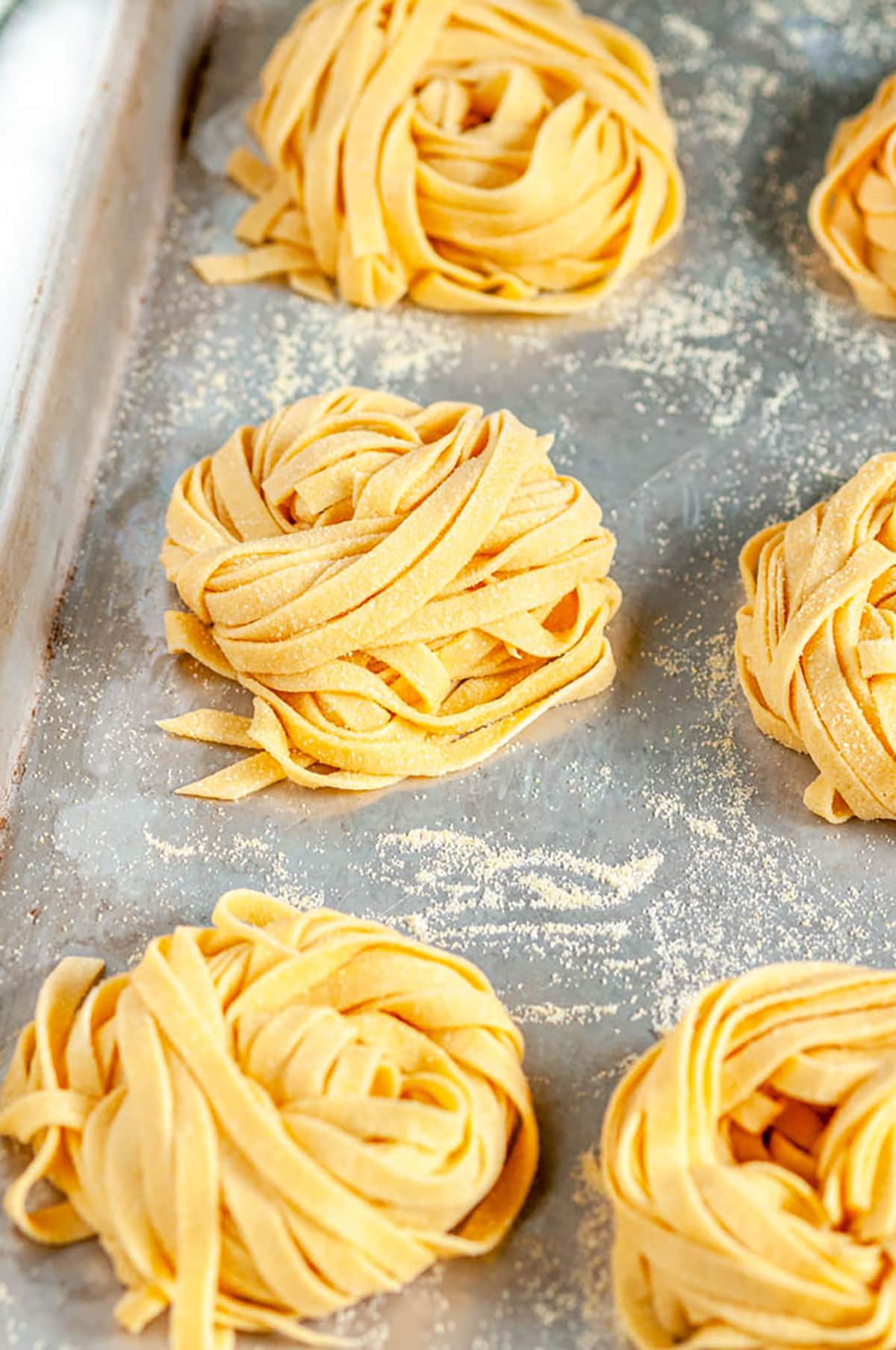 Homemade Pasta Dough Recipe nests on baking sheet